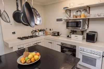 a kitchen with a bowl of fruit on a counter at Baruch Guest House Rhodes in Stellenbosch