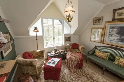 a living room with two chairs and a table at Baruch Guest House Rhodes in Stellenbosch