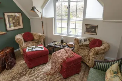 a living room with two chairs and a table at Baruch Guest House Rhodes in Stellenbosch