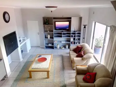 a living room with a couch and a tv at Somerset-West, Heldervue in Cape Town