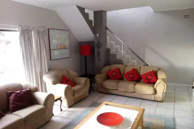 a living room with two couches and a staircase at Somerset-West, Heldervue in Cape Town