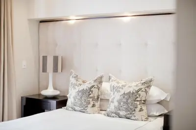 a bedroom with a white bed with pillows at Banksia Boutique Hotel & Spa in Cape Town