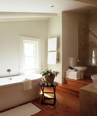 a bathroom with a tub and a toilet and a window at Banksia Boutique Hotel & Spa in Cape Town