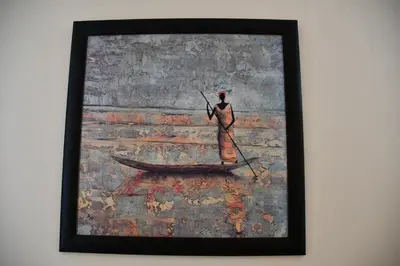 a painting of a man standing in a boat at Bradclin Sport Newlands in Cape Town