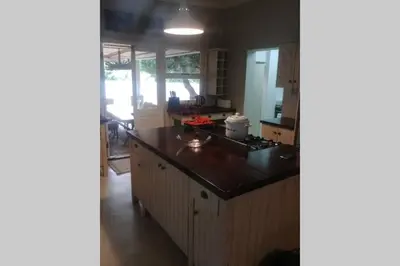 a kitchen with a counter top and a stove at Angel's Place by the Sea in Hermanus