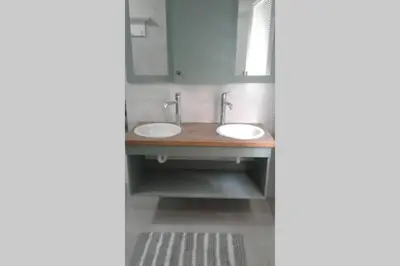 a bathroom with two sinks and a mirror at Angel's Place by the Sea in Hermanus