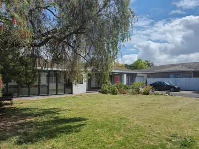 a house with a lawn in front of it at Lyronne Guest house, Shuttle and Tours in Cape Town