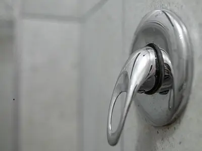 a metal door knob on a white wall at Lyronne Guest house, Shuttle and Tours in Cape Town
