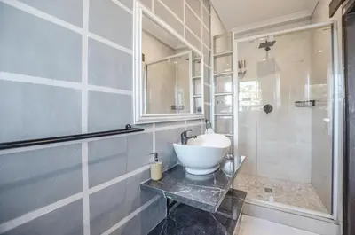 a bathroom with a sink and a shower at Casa Milner Guest House in Cape Town