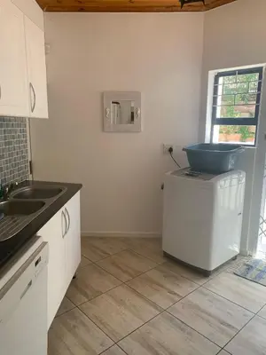a kitchen with a sink and a toilet on a counter at Hemel-en-See Beach House in Hermanus
