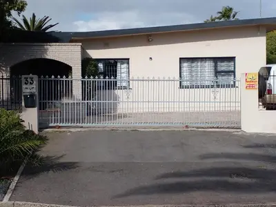 a white fence in front of a house at 33onGill in Cape Town
