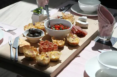 a table with a tray of food on a table at The Vineyard Cottage by L' Amitie Estate in Franschhoek