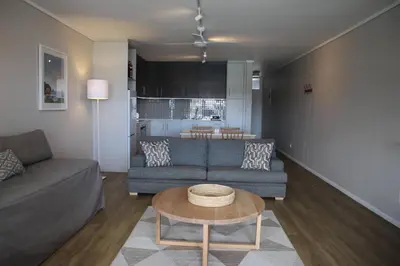 a living room with a couch and a table at The Boardwalk Accommodation in Gordonʼs Bay