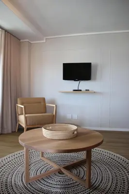 a living room with a coffee table and a tv at The Boardwalk Accommodation in Gordonʼs Bay