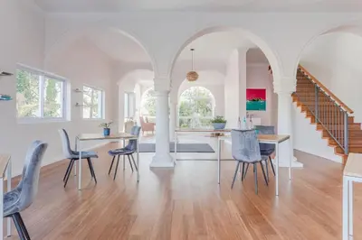 a living room with a dining table and chairs at The Views Guesthouse in Somerset West