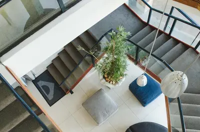 an overhead view of a staircase with potted plants at Strand Pavilion in Strand