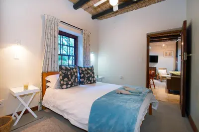 a bedroom with a large bed and a window at GreyCot in Greyton