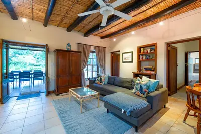 a living room with a couch and a table at GreyCot in Greyton