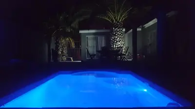 a swimming pool at night with a blue light at Hayley's Place in Cape Town