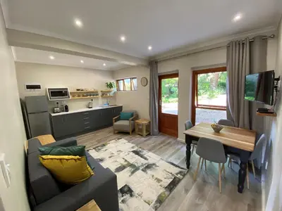 a living room with a couch and a table at Viettz Suite Annex in Stellenbosch