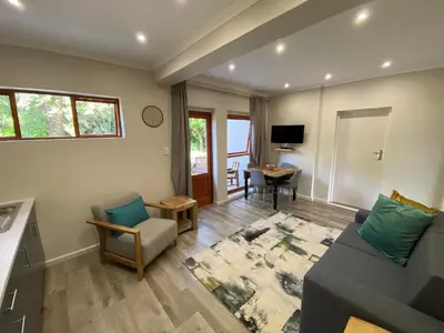 a living room with a couch and a table at Viettz Suite Annex in Stellenbosch