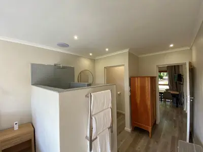 a kitchen with a refrigerator and a dining room at Viettz Suite Annex in Stellenbosch