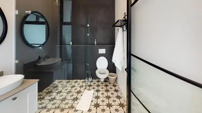 a bathroom with a toilet and a sink at McFarlane Residence by Top Destinations Rentals in Hermanus