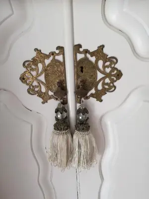 a chandelier with tassels on a white wall at At Leisure in Worcester