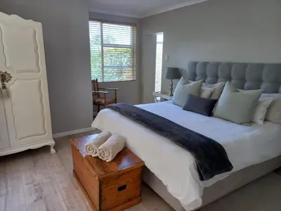 a bedroom with a large bed with towels on a table at At Leisure in Worcester