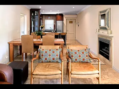 a dining room with a table and chairs and a fireplace at Sorbonne 1 - No loadshedding in Franschhoek