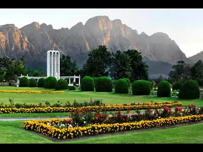 a garden with flowers in front of a mountain at Sorbonne 1 - No loadshedding in Franschhoek