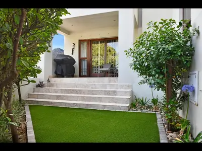 a house with stairs and a green lawn at Sorbonne 1 - No loadshedding in Franschhoek