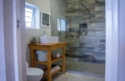 a bathroom with a sink and a toilet and a shower at Moortop Cottages in Elgin