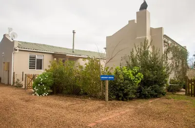 a house with a blue sign in front of it at Moortop Cottages in Elgin