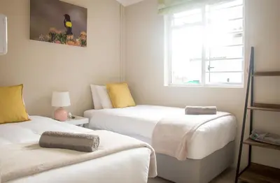 two beds in a small room with a window at Moortop Cottages in Elgin