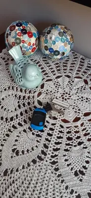 a table topped with a crochet table cloth with a cell phone at Goedehoop in Somerset West