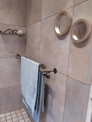 a bathroom with a towel rack and two toilets at Goedehoop in Somerset West