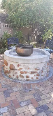 a stone fountain with a bowl on top of it at Goedehoop in Somerset West