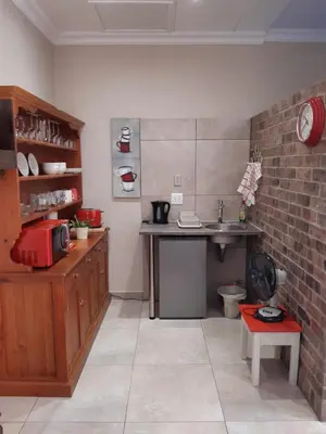 a kitchen with a counter and a sink in a room at Goedehoop in Somerset West