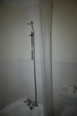 a bathroom with a bath tub and a toilet at On The Beach Front Sea Spray in Bloubergstrand