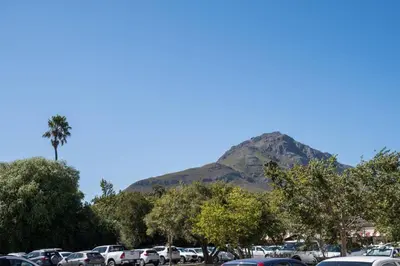 a parking lot with a mountain in the background at Apartment Claudia in Stellenbosch