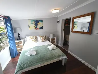 a bedroom with a bed with towels on it at The Blue Horizon House - Botrivier in Caledon