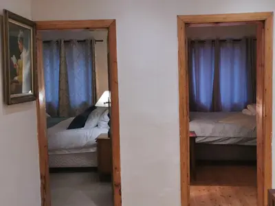 a mirror in a room with two beds in it at The Blue Horizon House - Botrivier in Caledon
