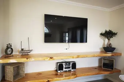 a room with a wooden shelf with a microwave on it at The Blue Horizon House - Botrivier in Caledon