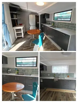 a kitchen with blue chairs and a table at The Blue Horizon House - Botrivier in Caledon