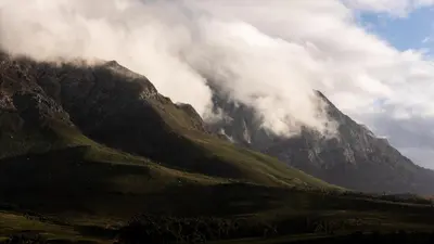 a mountain obscured by clouds in front of a mountain at Eikehof Farm in Worcester