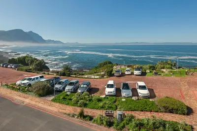 an aerial view of a parking lot with cars parked at Walker Bay Luxury Seafront Apartment in Hermanus