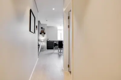 an open door to a white room with a hallway at Axis - Century City Self Catering Apartment in Cape Town