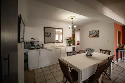 a kitchen and dining room with a table and chairs at Broadway Tygervalley House in Cape Town