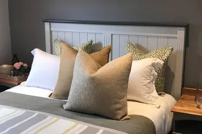 a bed with a bunch of pillows on it at Winner in the Winelands in Franschhoek
